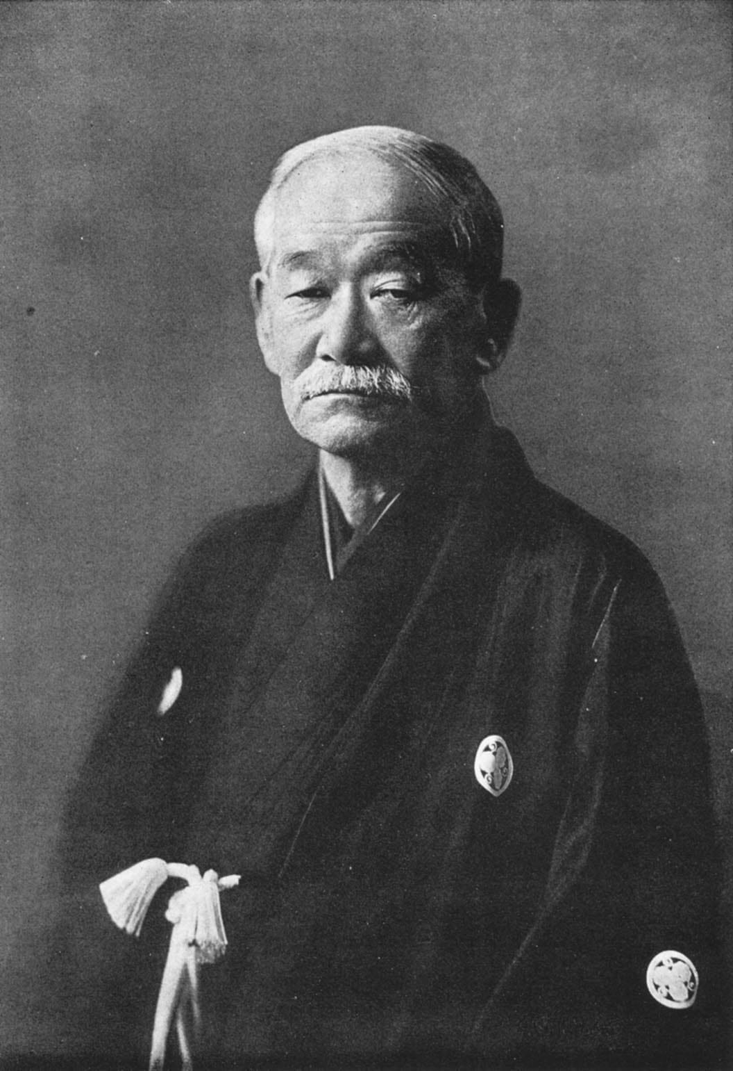 A black-and-white portrait photograph of Kanō Jigorō, founder of Kōdōkan judo.