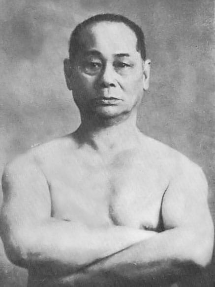 A black-and-white photograph of Motobu Chōki in a fighting stance.