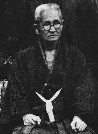 A black-and-white portrait photograph of Kyan Chōtoku, teacher of Shōrin-ryū Seibukan's founder.