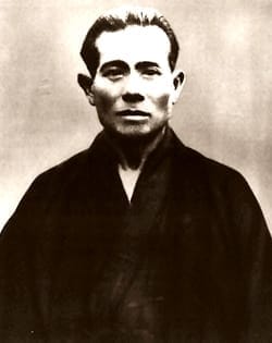 A black-and-white portrait photograph of Uechi Kanbun, founder of Uechi-ryū.